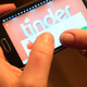 A photo of a person using the Tinder app on a Samsung smartphone.
